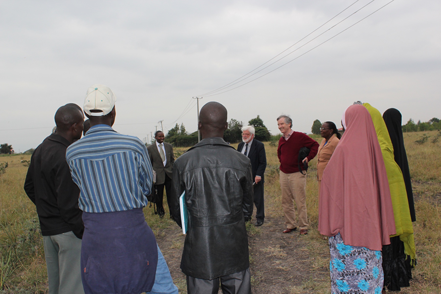 Clifford Dann discussing the project on site with MWAMKO and CHG members, with the Project Manager on his right.