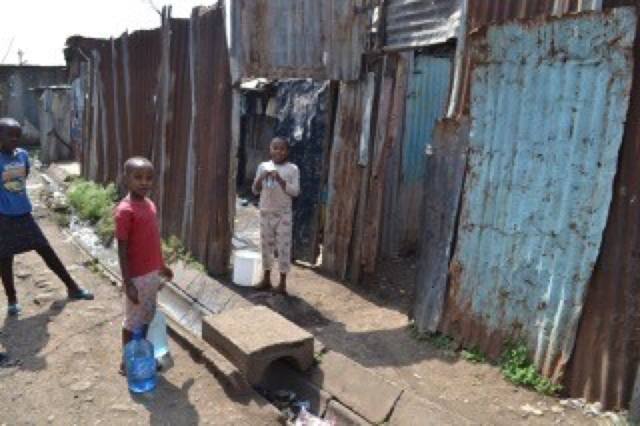 A typical household: Households in Korogocho don’t have access to clean water at home. It has to be bought and is quite expensive. These heavy containers are carried home by children or by women. These makeshift structures are homes.