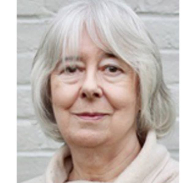 Valerie Kent, with grey hair, in a cream top.