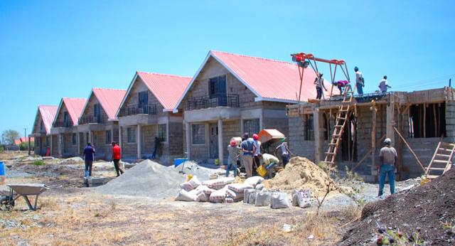 The first five completed houses at Kamulu in a row, with the sixth house beginning on the right.